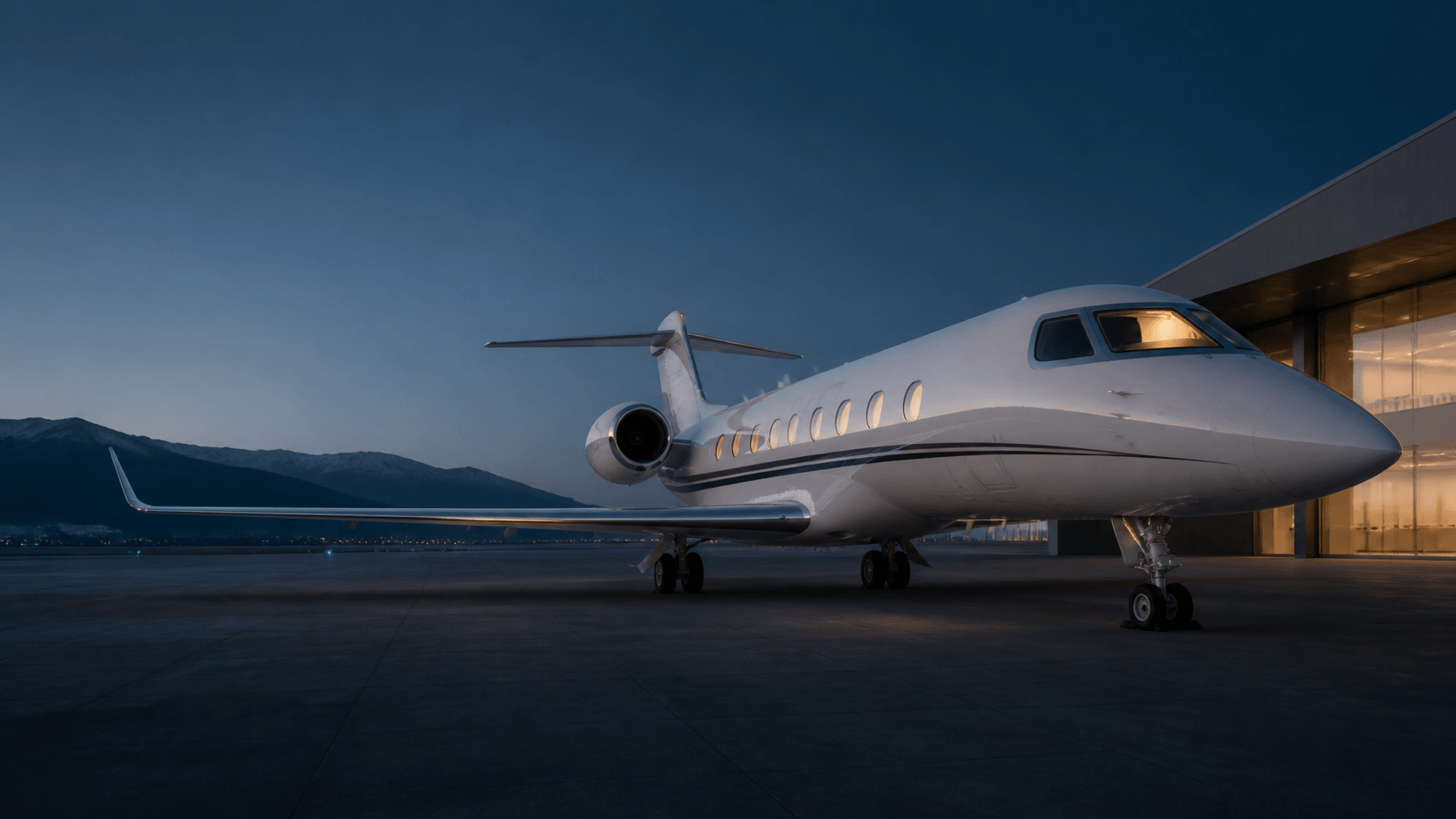A private jet waiting on the ramp at dusk